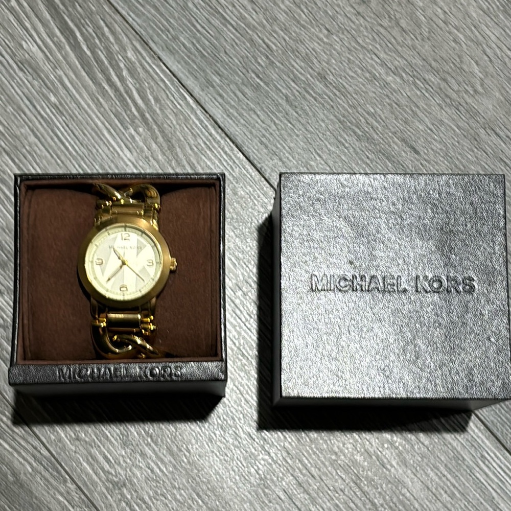 Michael Kors chain link gold-tone stainless steel watch.